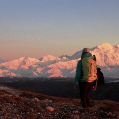 a man standing in front of a mountain