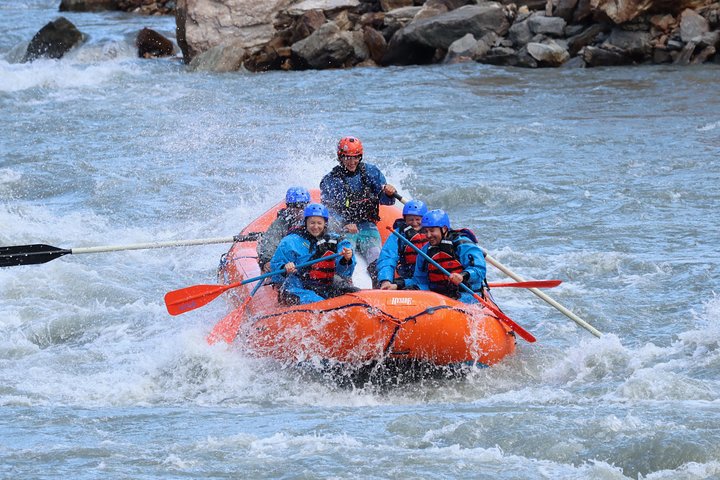 a man riding on a raft in a body of water