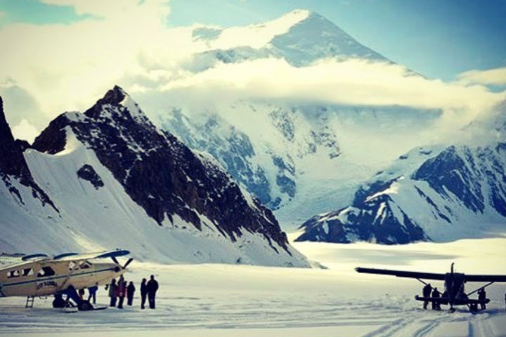 a group of people riding skis on top of a snow covered mountain