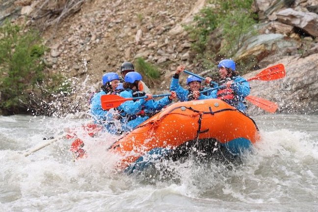 a group of people on a raft in the water