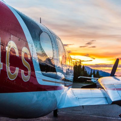 a blue and white plane sitting on top of a field