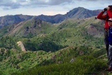 a man standing in front of a mountain